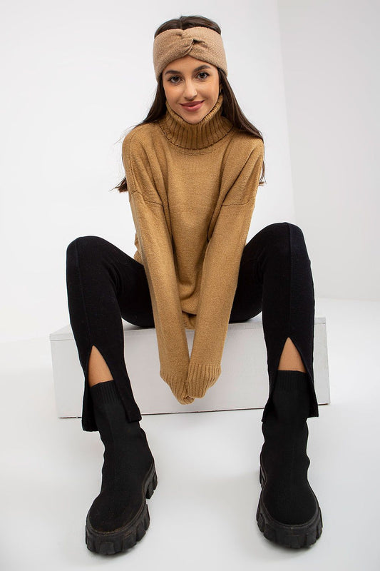 Luxurious women's turtleneck sweater, elegantly draped, paired with stylish black split leggings and trendy ankle boots, showcasing a perfect blend of comfort and high-fashion.
