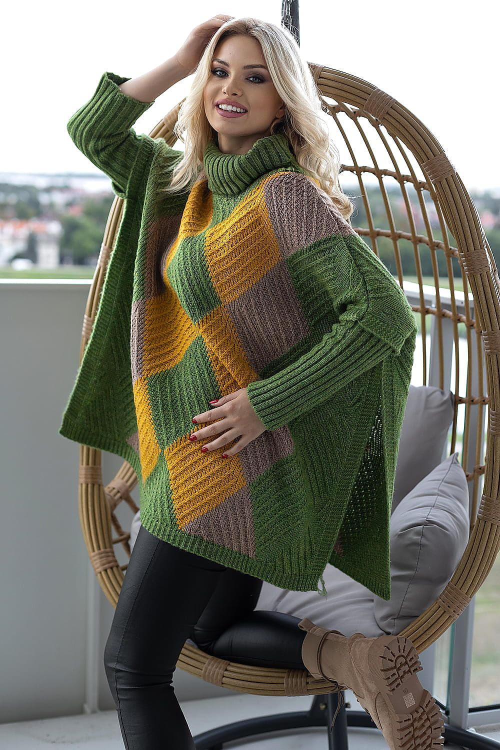 Luxurious women's turtleneck poncho sweater in rich green, yellow, and brown hues, featuring a soft, fluffy knit and long sleeves, showcased by a stylish model against a scenic backdrop, ideal for elevating any chic winter wardrobe.