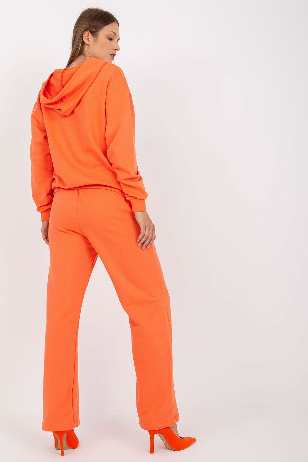 Luxury women's 2-piece cotton hoodie sweatshirt set in vibrant orange, featuring long sleeves, a hood, and matching long pants with pockets, showcasing modern style and comfort.
