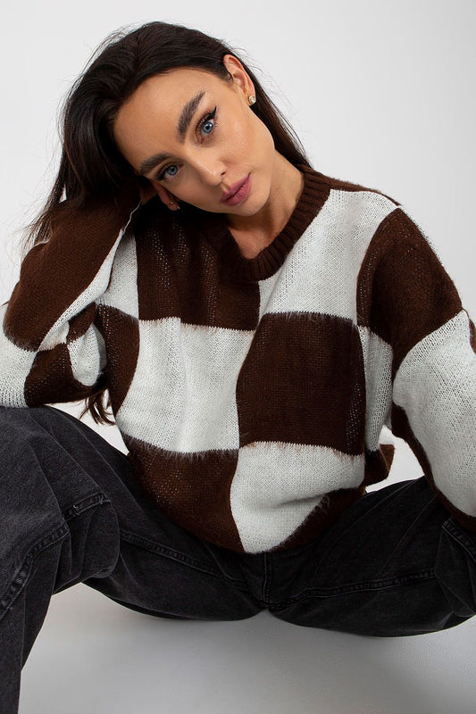 Close-up of a chic women's long-sleeve acrylic sweater featuring a stylish brown and white check design, highlighting elegant neckline and relaxed fit.