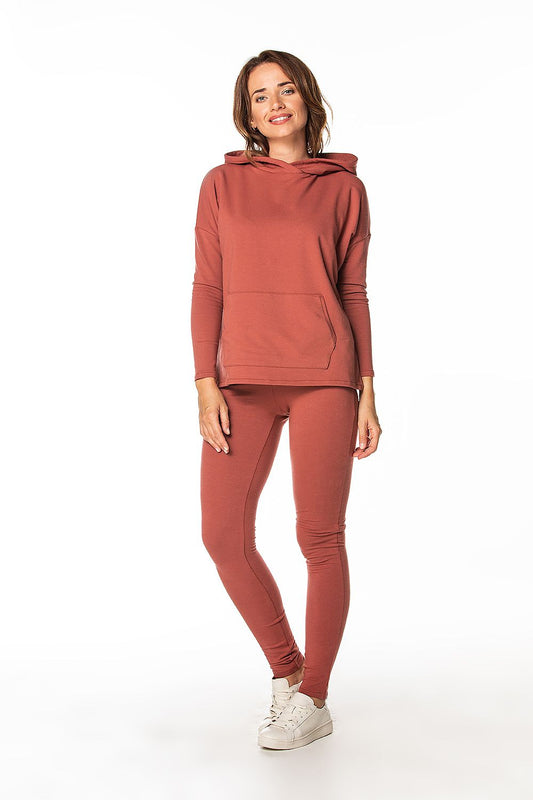 Model wearing a coordinating Luxury Tessita cotton knit tracksuit, featuring warm trousers and a pullover, perfect for an elegant yet casual look.
