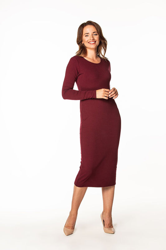 Charming view of a burgundy cotton knit dress with long sleeves and boat neckline, elegantly displayed by Tessita, perfect for any occasion.