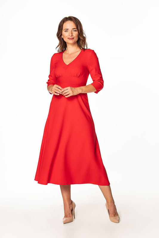 Stylish red maxi dress featuring 3/4 sleeves and pleated bust worn by a confident model, designed by Tessita for a refined and luxurious look.