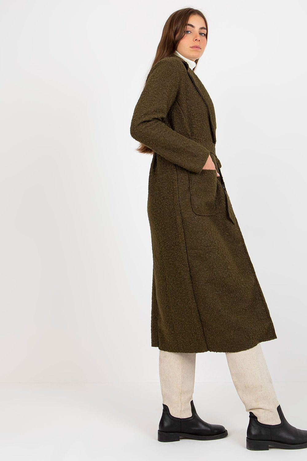Side profile of a classy green coat by Och Bella, featuring a belt and patch pockets, epitomising contemporary elegance in women's outerwear.