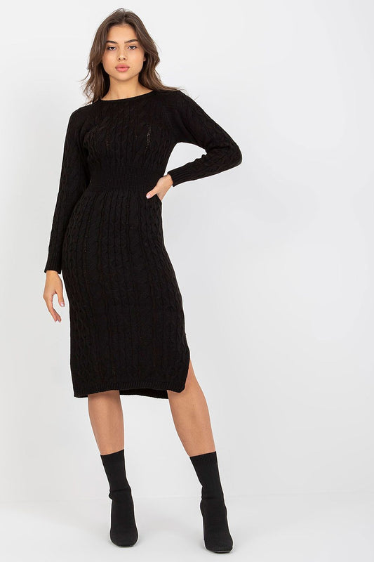 Front view of an elegant black long sleeve knitted daydress with a fitted silhouette, complemented by stylish ankle boots, perfect for versatile day-to-night wear.