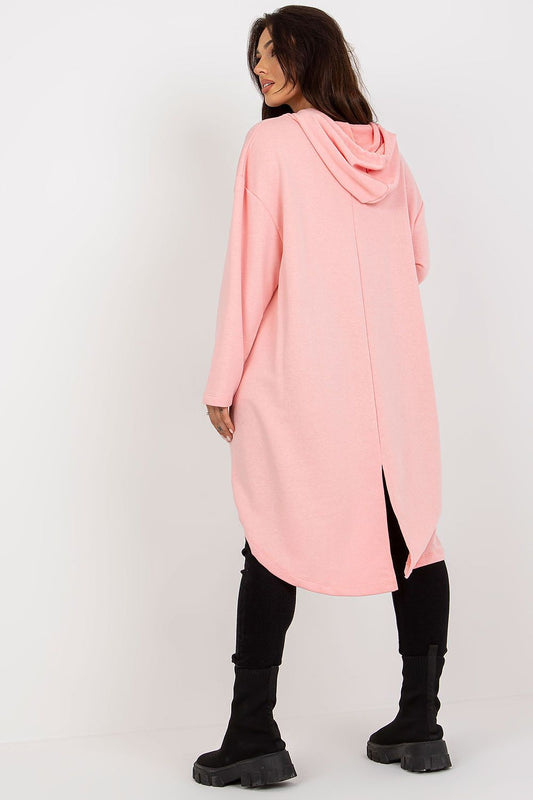 Back view of a fashionable women's pink hoodie sweatshirt, showcasing its long sleeves and asymmetrical cut, styled with black fashion leggings and chic knee-high boots for a sophisticated look.