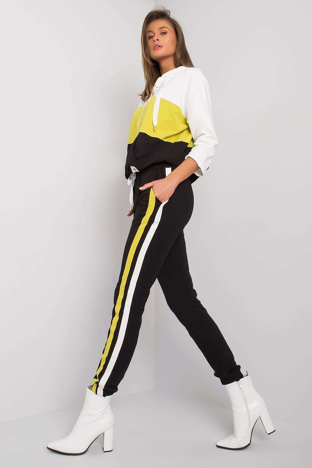 Elegant women's cotton sweatshirt set in vibrant colours, featuring a stylish 3/4 sleeve hooded top and chic long pants with side stripes, complemented by trendy white heels, perfect for a luxurious casual look.