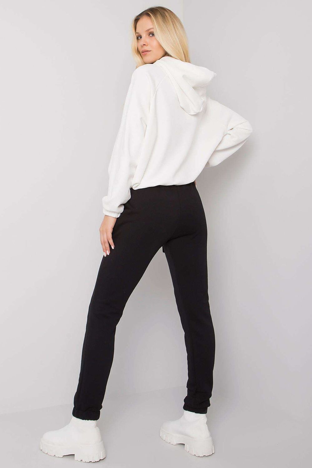 Elegant Relevance cotton and spandex sweatshirt set, featuring a hooded long-sleeve sweatshirt paired with stylish black waist tie pants, showcased in a chic studio setting.