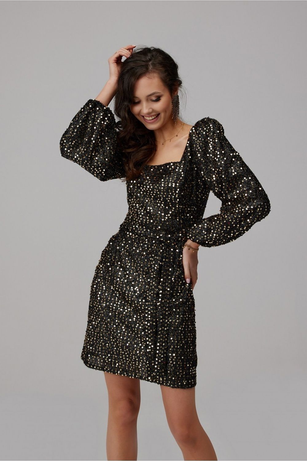 Chic black sequin mini dress with voluminous puff sleeves, tailored for a glamorous look, highlighting sophistication and style.