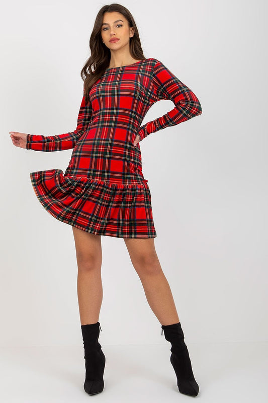 Elegant red and black checkered velour dress featuring long sleeves and a flowy frill at the hem, presented by a model in a chic pose.