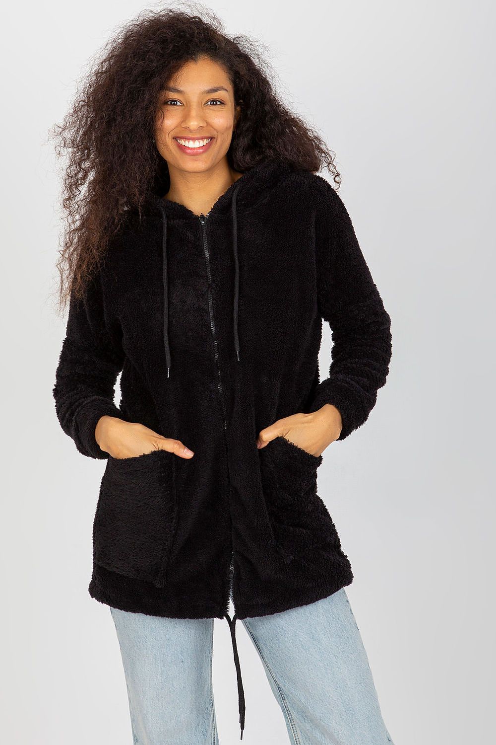 Sophisticated black fur zip-up sweatshirt with a hood, elegantly worn by a woman with curly hair, highlighting its stylish design and functional slip pockets.