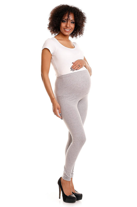 Chic grey maternity leggings showcased by a pregnant model in a graceful pose, emphasising comfort and style during pregnancy.