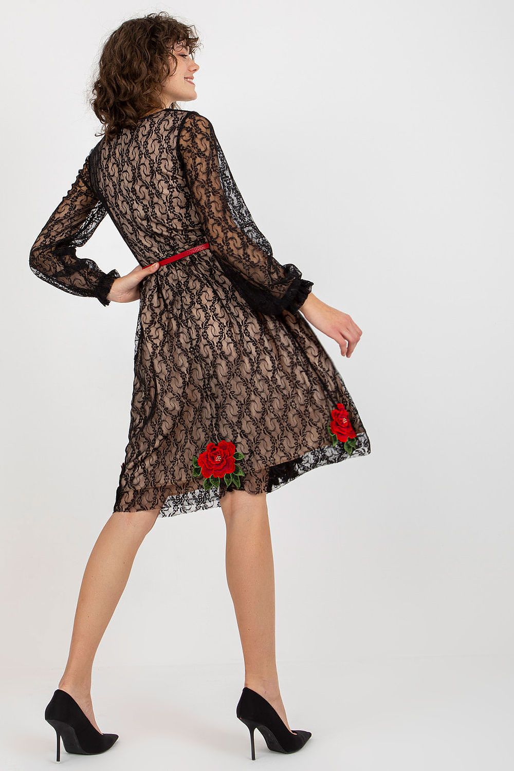 Back view of a sophisticated lace evening dress, showcasing floral accents and a flattering silhouette, enhanced by a red belt.