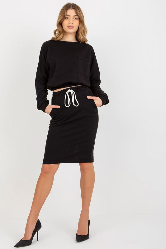 Stylish black Ex Moda tracksuit set with a cropped long sleeve sweatshirt and a waist tie skirt, perfectly paired with high heels for a chic outfit.