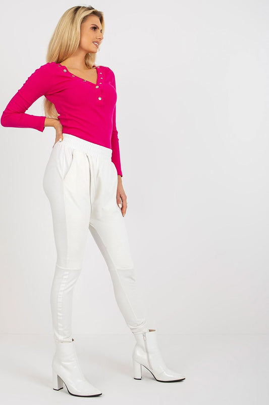 Stylish profile view of a woman wearing high waist tracksuit trousers and pink top, showcasing the modern design and luxurious aesthetic.