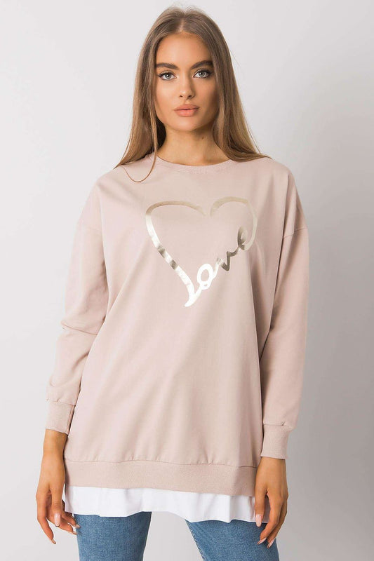 Sophisticated view of a Rue Paris loose-fitting tunic showcasing a metallic heart design, elegantly paired with jeans, ideal for chic everyday fashion.