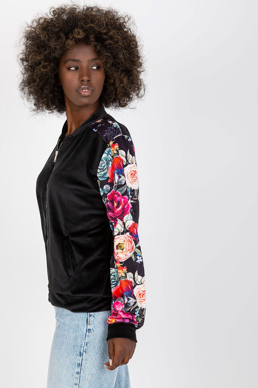 Detailed view of the Luxurious Velour Bomber Jacket by Rue Paris featuring colourful floral patterns and practical slip pockets, ideal for a chic casual look.