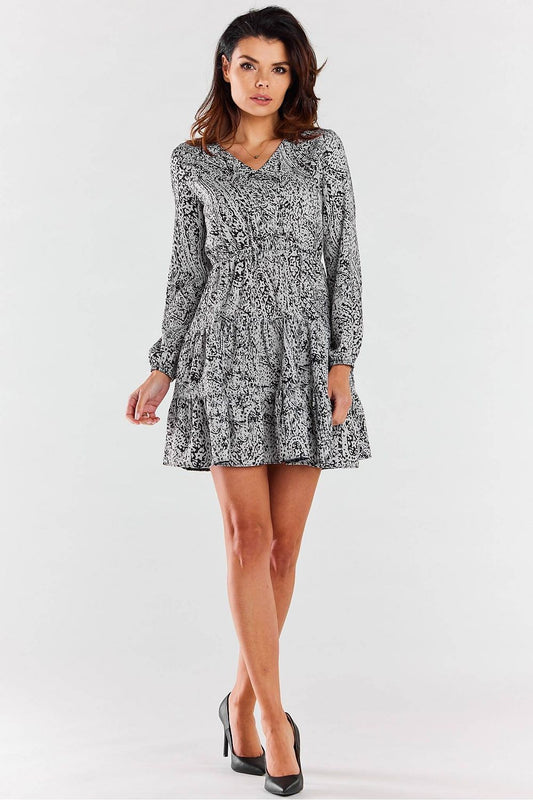 Chic Awama mini dress with long sleeves and V neckline, styled for formal and casual occasions.