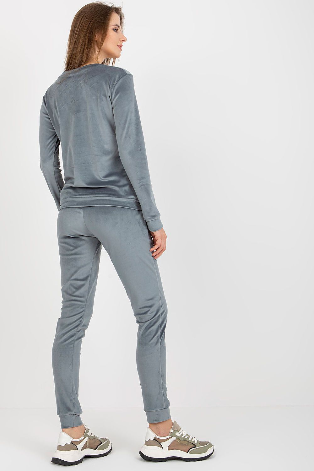 Rear view of the luxurious grey velour pants and blouse ensemble by Relevance, emphasizing stylish details and a flattering fit.