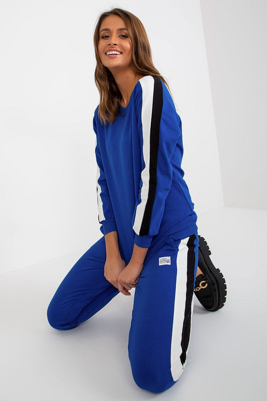 Chic and modern blue sweatshirt set by Relevance, accentuated with decorative stripes. Model in a playful pose, highlighting the stylish tie-waist pants and luxurious fabric blend.