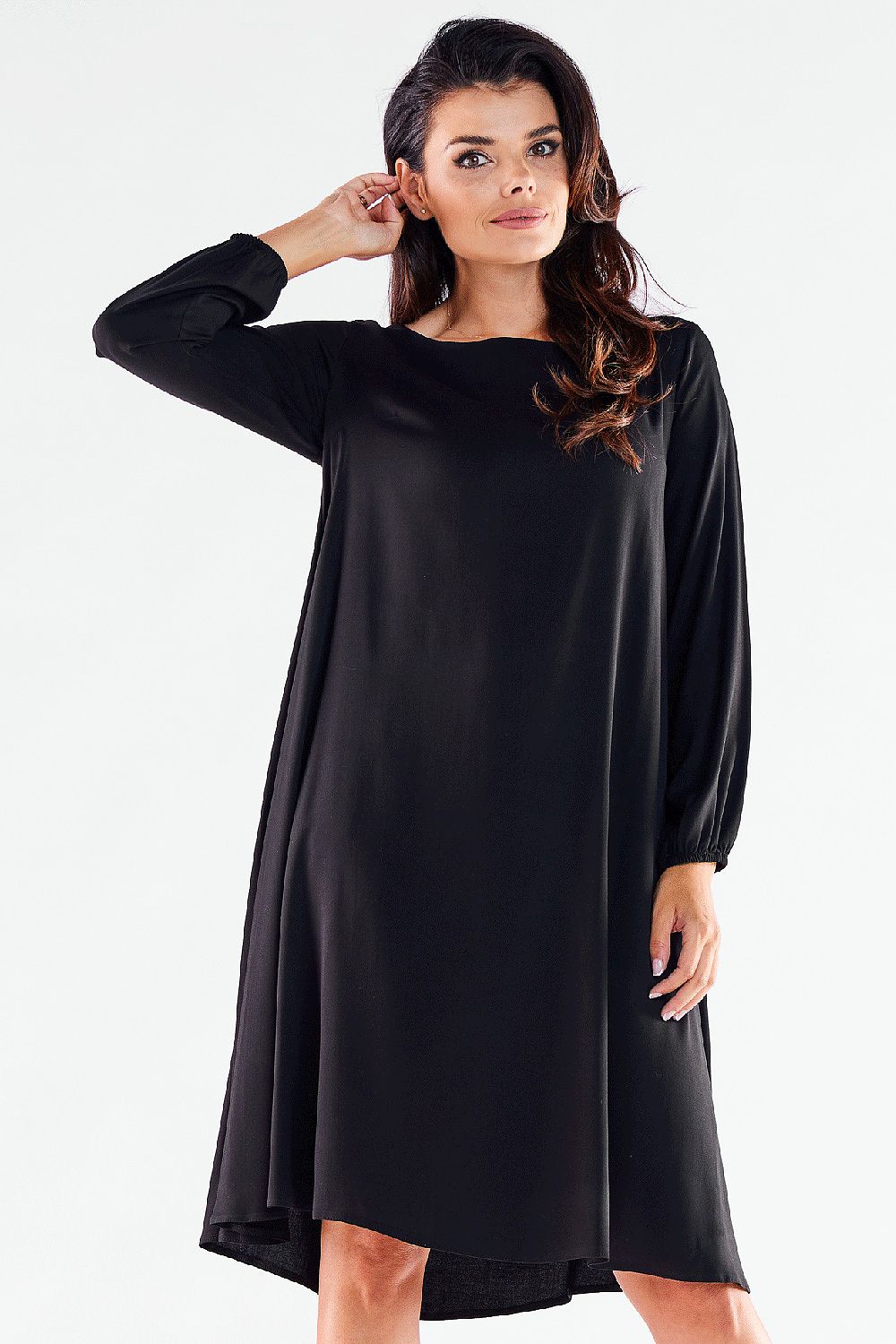 Stylish black trapezoidal daydress with long sleeves, showcasing a graceful silhouette, ideal for both casual and formal settings, posed from the front.
