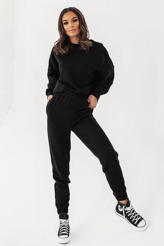 Model in Ivon black oversized sweatshirt paired with matching joggers, epitomising chic loungewear.