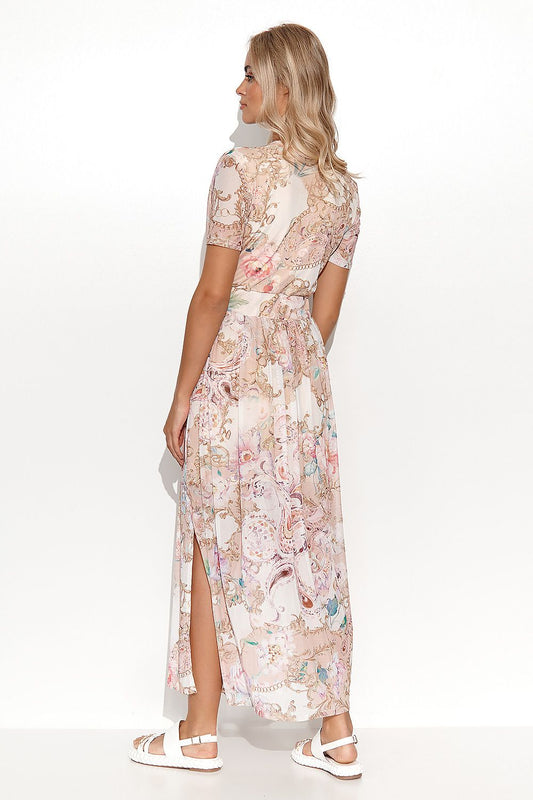 Back view of the luxurious Makadamia mini dress with a flattering silhouette, adorned with vibrant floral patterns and a practical slit, ideal for chic summer styling.