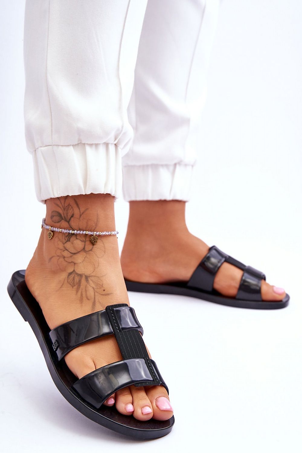 Stylish close-up of ZAXY vegan flip-flops in sleek black, highlighting the comfortable fit and eco-friendly design, perfect for elevating any outfit with a touch of luxury.