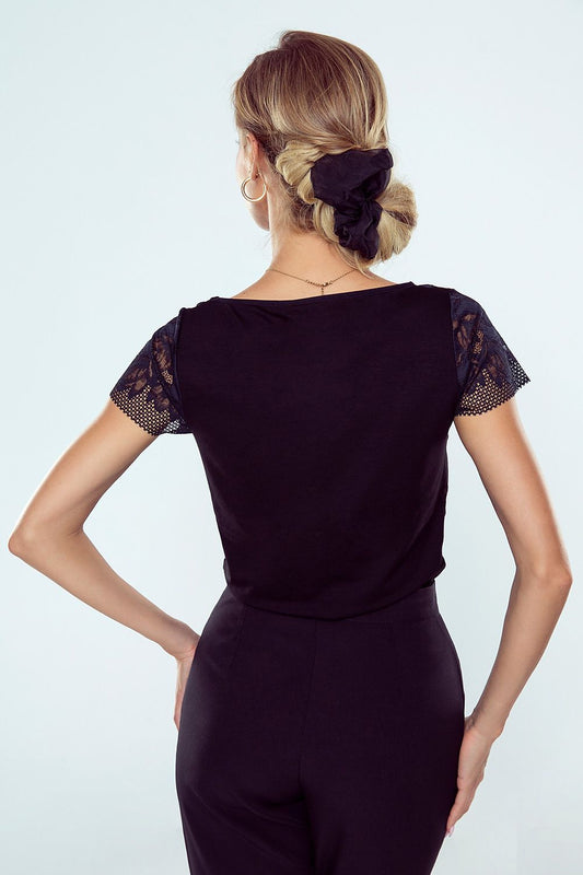Back view of the sophisticated black blouse by Eldar Fashion, showcasing intricate lace cap sleeves and a sleek silhouette, ideal for upscale occasions.