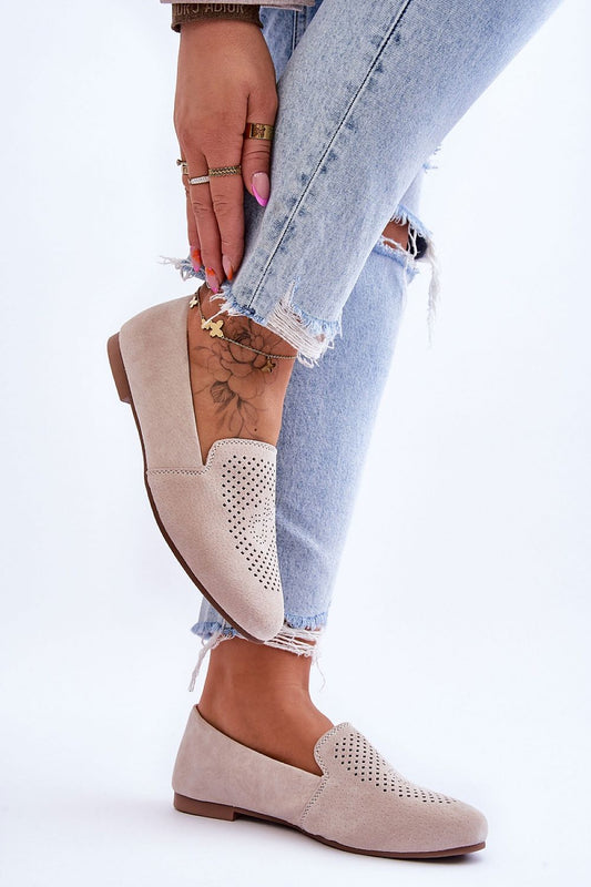 Elegant women's suede moccasins featuring a detailed perforated pattern, designed for comfort and style, complemented by distressed denim by Step in Style.