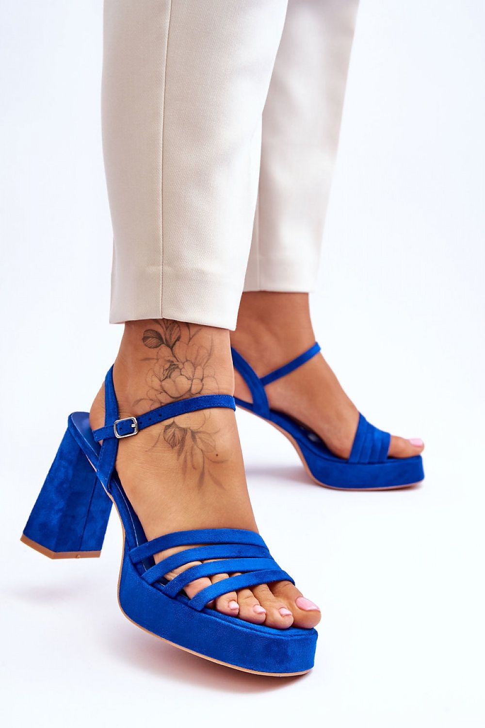 Chic blue platform heel sandals with adjustable ankle strap, styled elegantly with tailored trousers, exclusively from Step in Style.