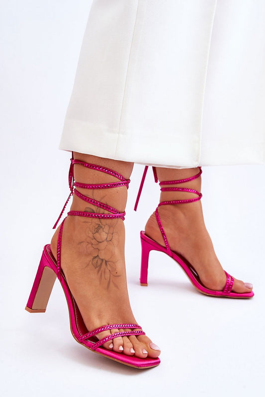 Elegant close-up of pink strappy sandals with decorative rhinestones, designed with calf ties and a 9.5 cm heel, by Step in Style.