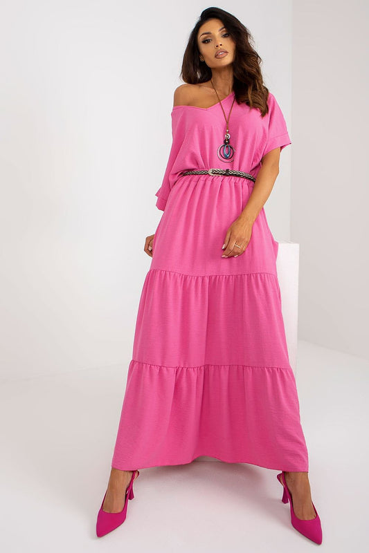 Elegant pink summer maxi skirt by Italy Moda, featuring delicate frills and a matching belt, showcased in a luxurious setting, ideal for sophisticated outdoor events.