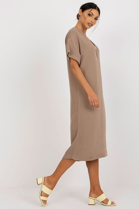 Side profile of a sophisticated Och Bella shirt dress with a heart neckline, made from a premium cotton, linen, and viscose blend. The model displays the dress's flattering silhouette.