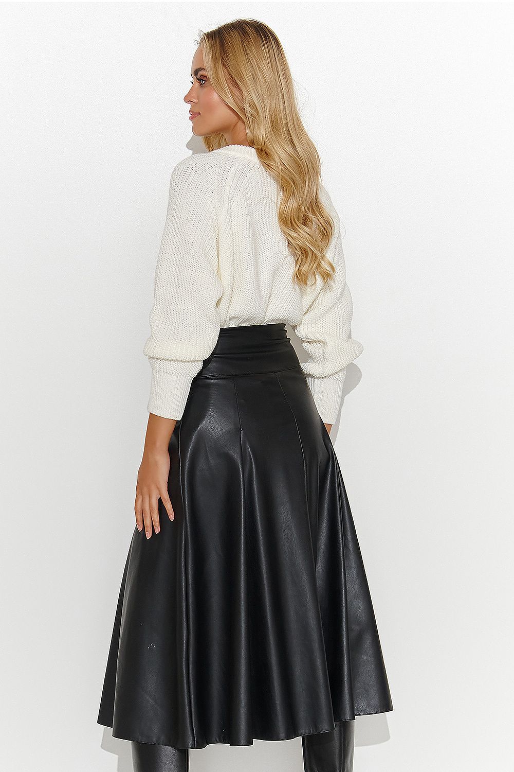 Elegant Makadamia leather midi skirt paired with chic boots, designed to transition effortlessly from evening outings to business meetings.