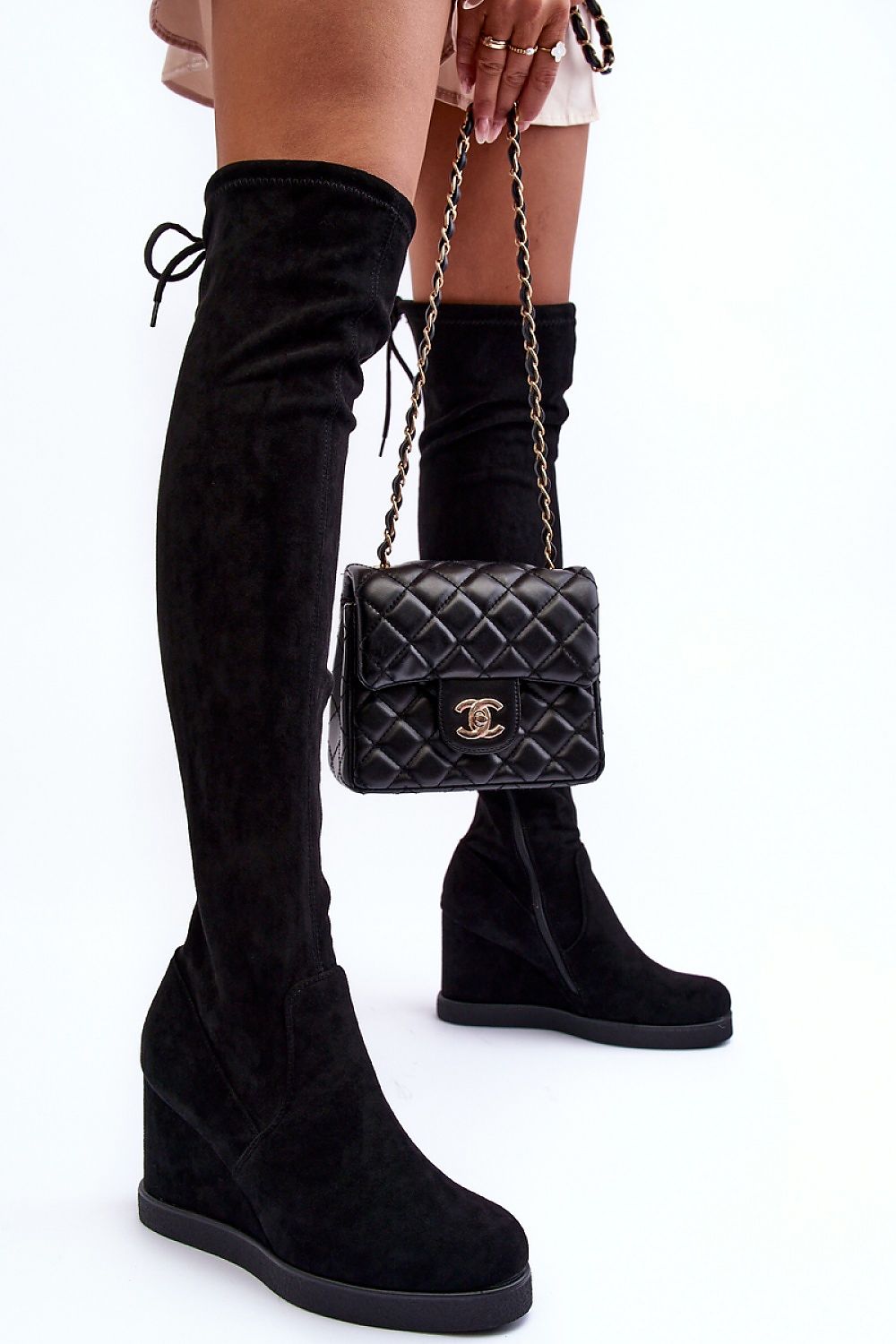 Elegant women's buskin boots by Step in style featuring a tied upper and side zipper, complemented by a stylish black quilted handbag, set against a minimalist white backdrop, showcasing the 9.5 cm heel and faux leather material.