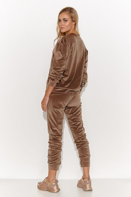 Elegant velour tracksuit set for women showcasing a chic heart neckline sweatshirt and stylish tapered pants, combining comfort and sophistication.