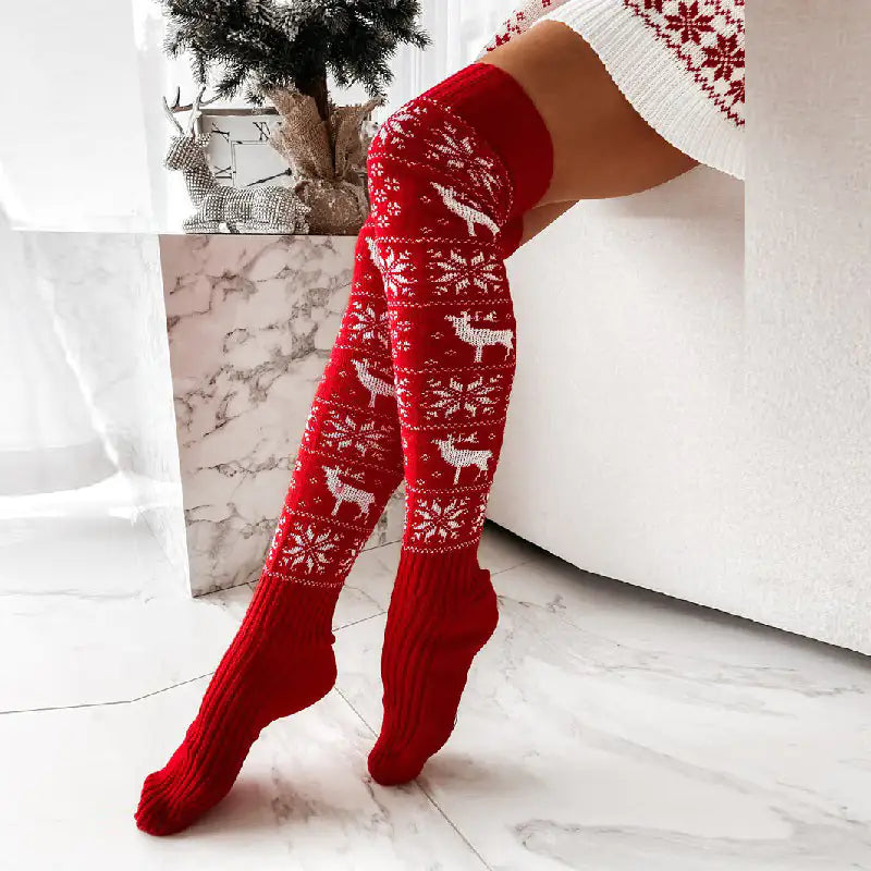 Elegant display of CozyClaus Women's Festive X-Mas Stockings in vibrant red, adorned with charming reindeer, set against a chic interior.