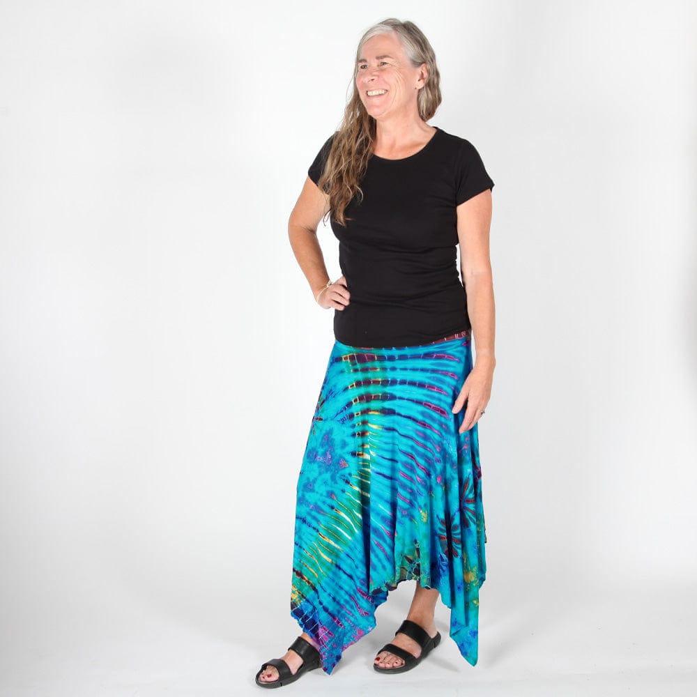 Full-length image of confident model wearing fashionable tie dye midi skirt, styled with fitted top, embodying modern elegance and versatility.