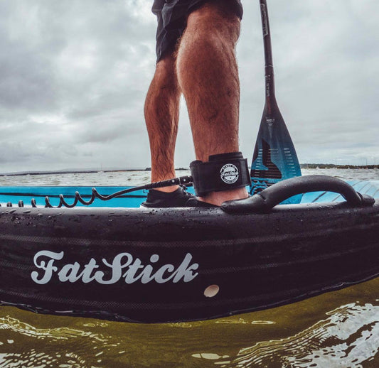 Premium paddling equipment, showcasing the coiled design of a 10ft SUP ankle leash designed for comfort and reliability during your aquatic adventures.