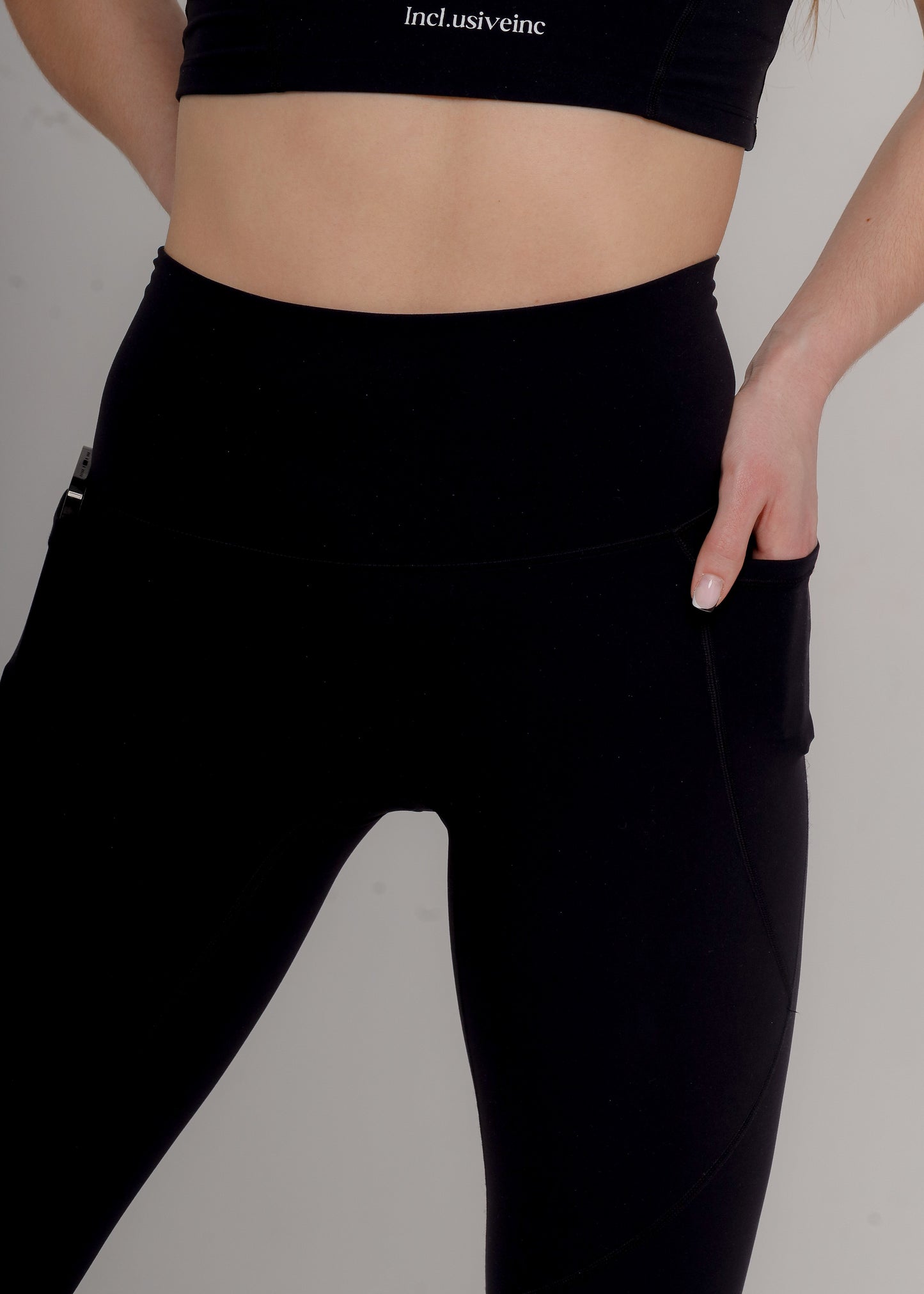 Stylish Premium Active Black Leggings with secure back zip pocket by Incl.usiveinc, designed for practicality and elegance.