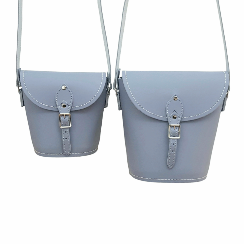 Stylish and compact Handmade Lilac Grey Leather Barrel Bag displayed in a lifestyle setting, highlighting spacious inner compartment for essentials.