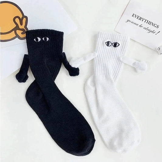 Stylish display of Novelty Romantic Magnetic Holding Hands Couple Socks in black and white, featuring whimsical details that enhance the charm of couple coordination.