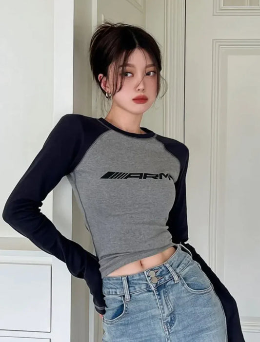 Elegant Women's Grey Black Contrast Color Slim Long Sleeve Tee, capturing a sophisticated look in a fashionable pose, perfect for modern style.
