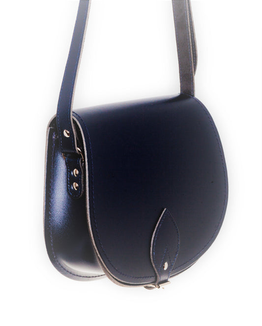 Versatile handmade navy leather saddle bag with an adjustable crossbody strap, perfectly crafted for luxury and functionality.