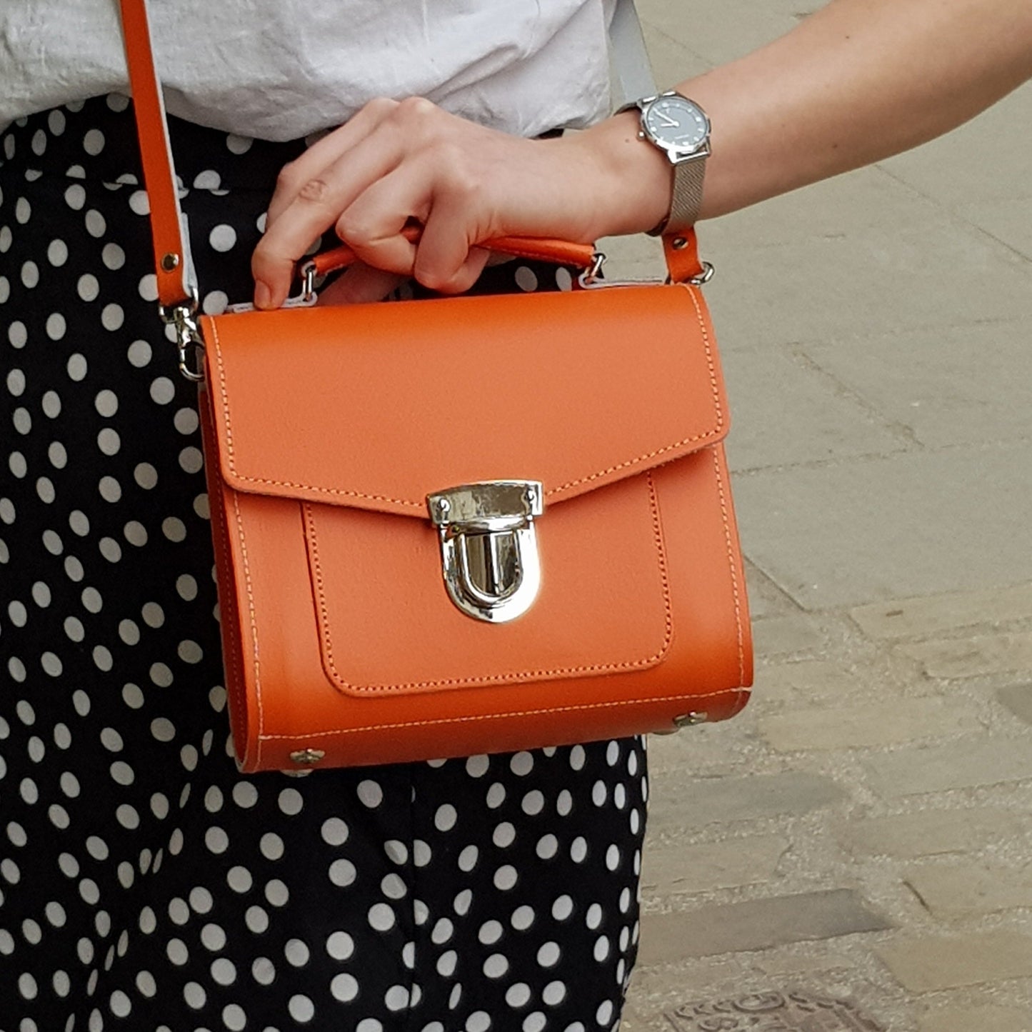 Model displaying the Handmade Orange Leather Sugarcube Handbag in Plus size, demonstrating versatility and stylish appeal for various occasions.