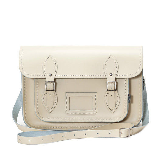 Close-up of the luxurious pastel cream leather texture and matching cable stitching of the handcrafted satchel.