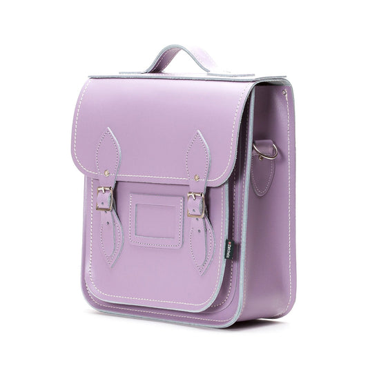 Close-up of pastel violet leather city backpack highlighting silver nickel buckles and matching stitching, exemplifying luxury and elegance in everyday fashion.