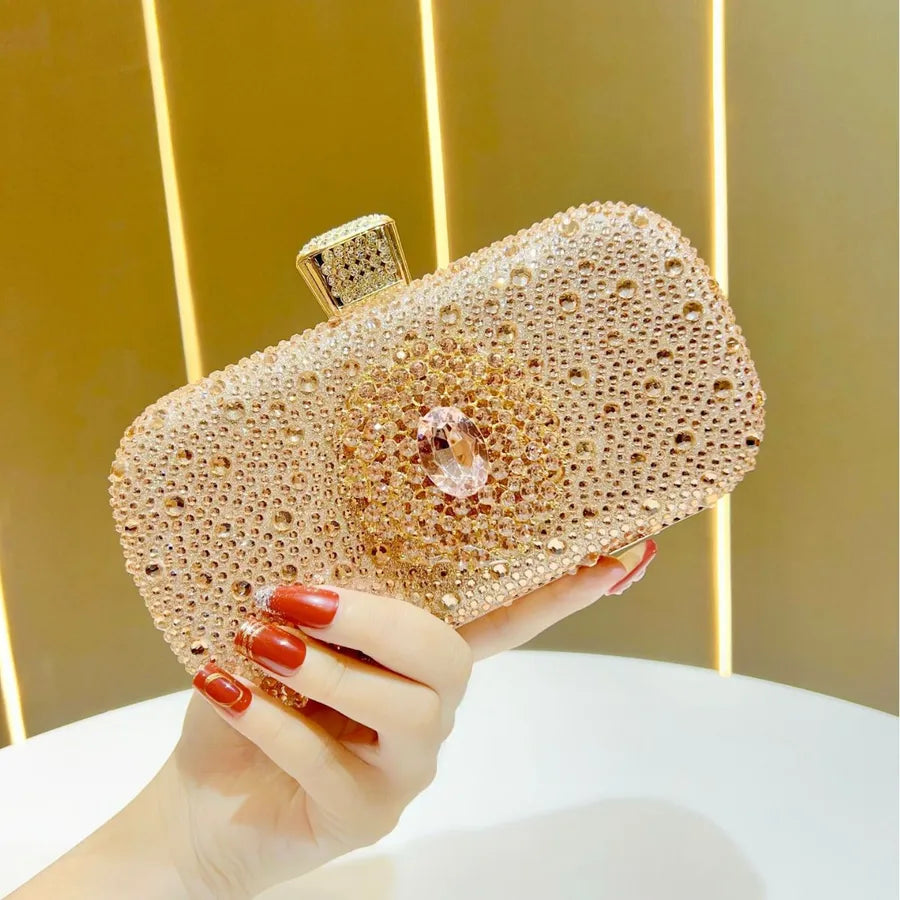 Elegant clutch featuring a chain handle, adorned with sparkling diamond accents, perfectly suited for weddings and upscale occasions.