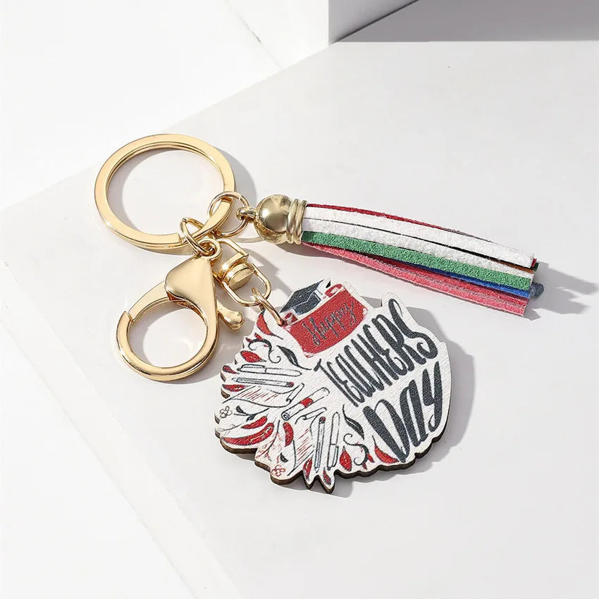 Sophisticated wooden keychain with a trendy rainbow tassel, designed for discerning teachers and graduates.
